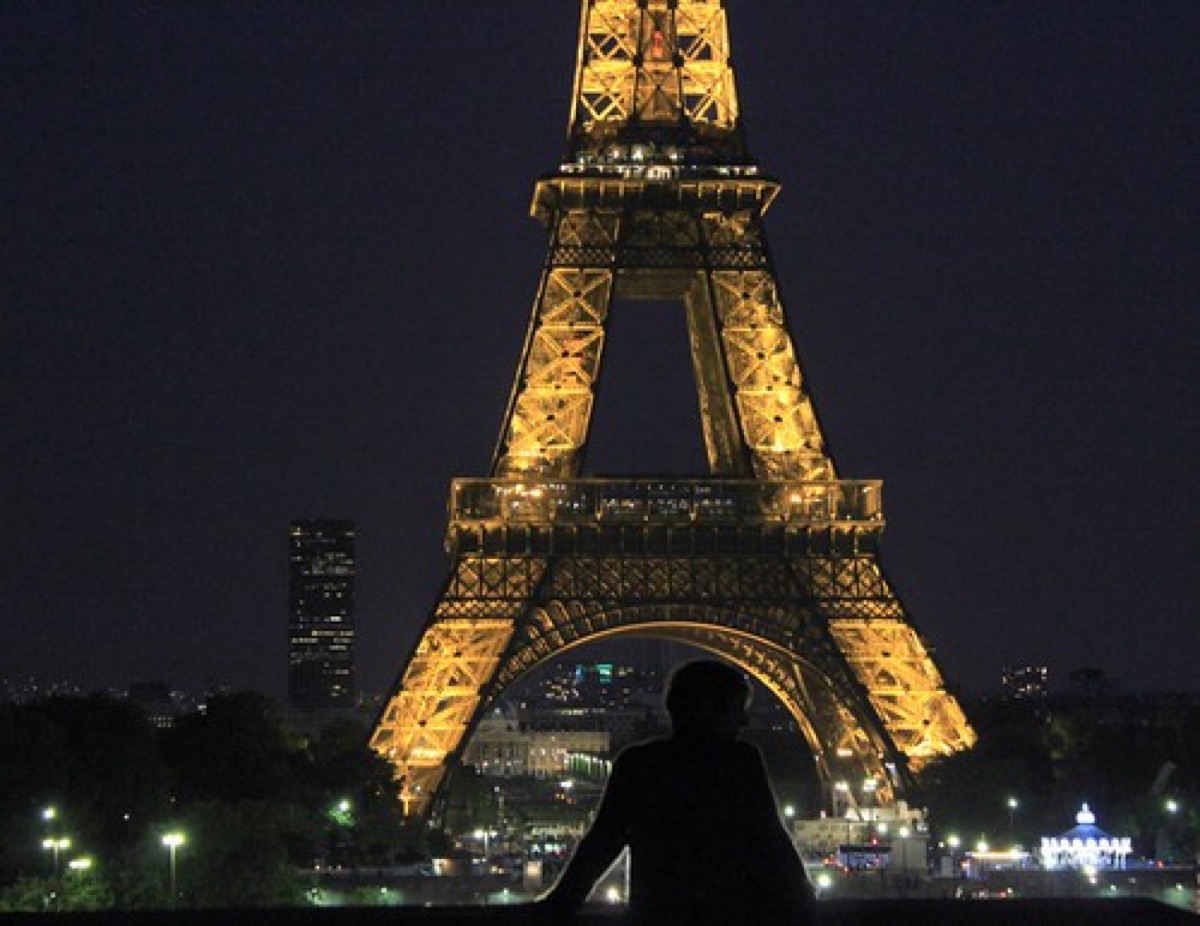 Eiffel Tower illuminated at night, highlighting Paris's iconic landmark