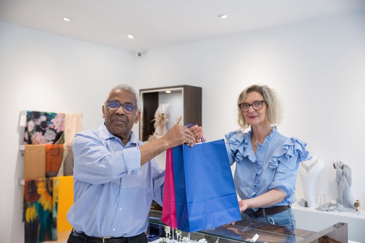 Shopping bag with Parisian luxury items at boutique