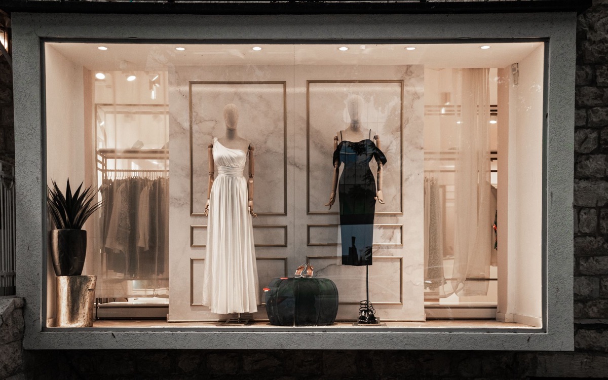 Paris luxury boutique window display with elegant products and soft natural light